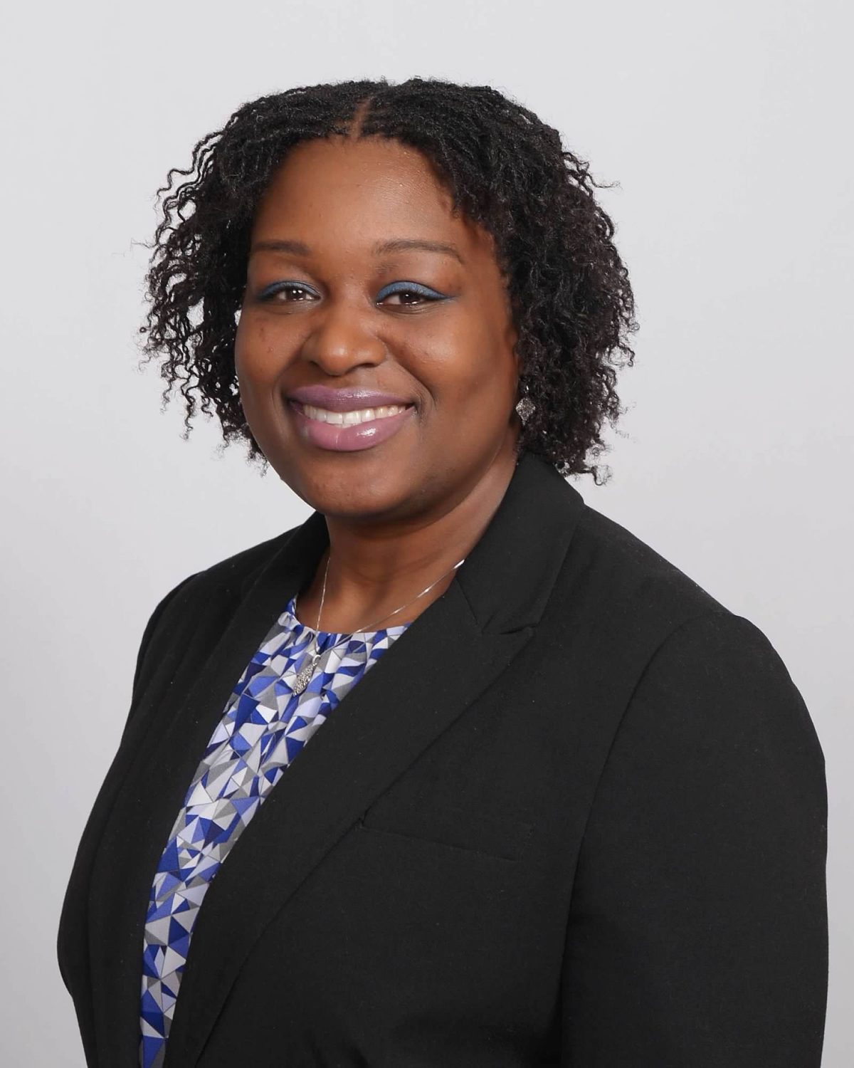 Portrait of Rovna-Lyn T. Joseph in a black blazer